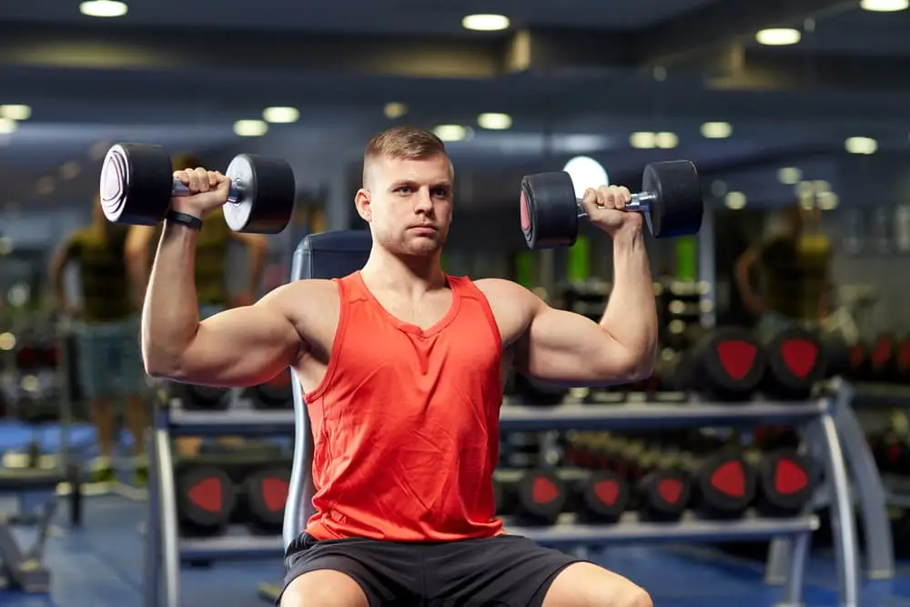 Dumbbell shoulder press in an upper body CrossFit strength routine