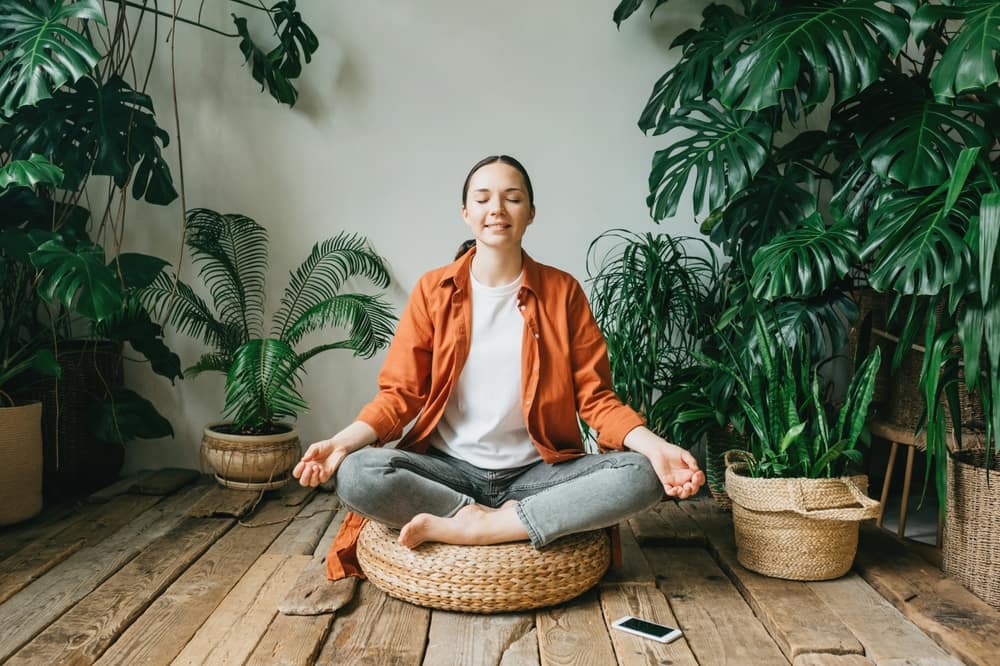 Person meditating with glowing thoughts