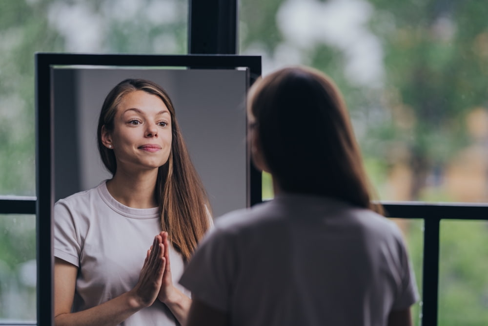 Woman practicing mirror affirmations