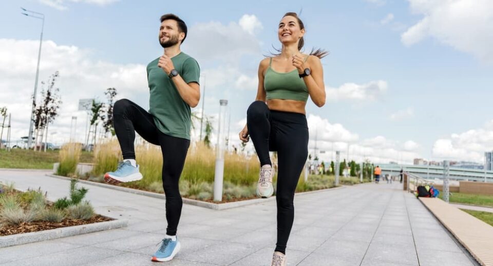 Man and woman walking together outdoors as part of daily walking routines, promoting health, fitness, and well-being.