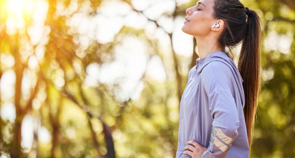 Woman enjoying outdoor relaxation, practicing one of the best offline hobbies to improve mental wellness in nature.