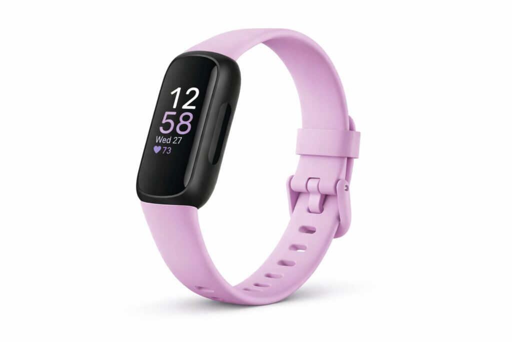 Fitbit Inspire 3 health and fitness tracker with pink band showing heart rate and activity tracking display.